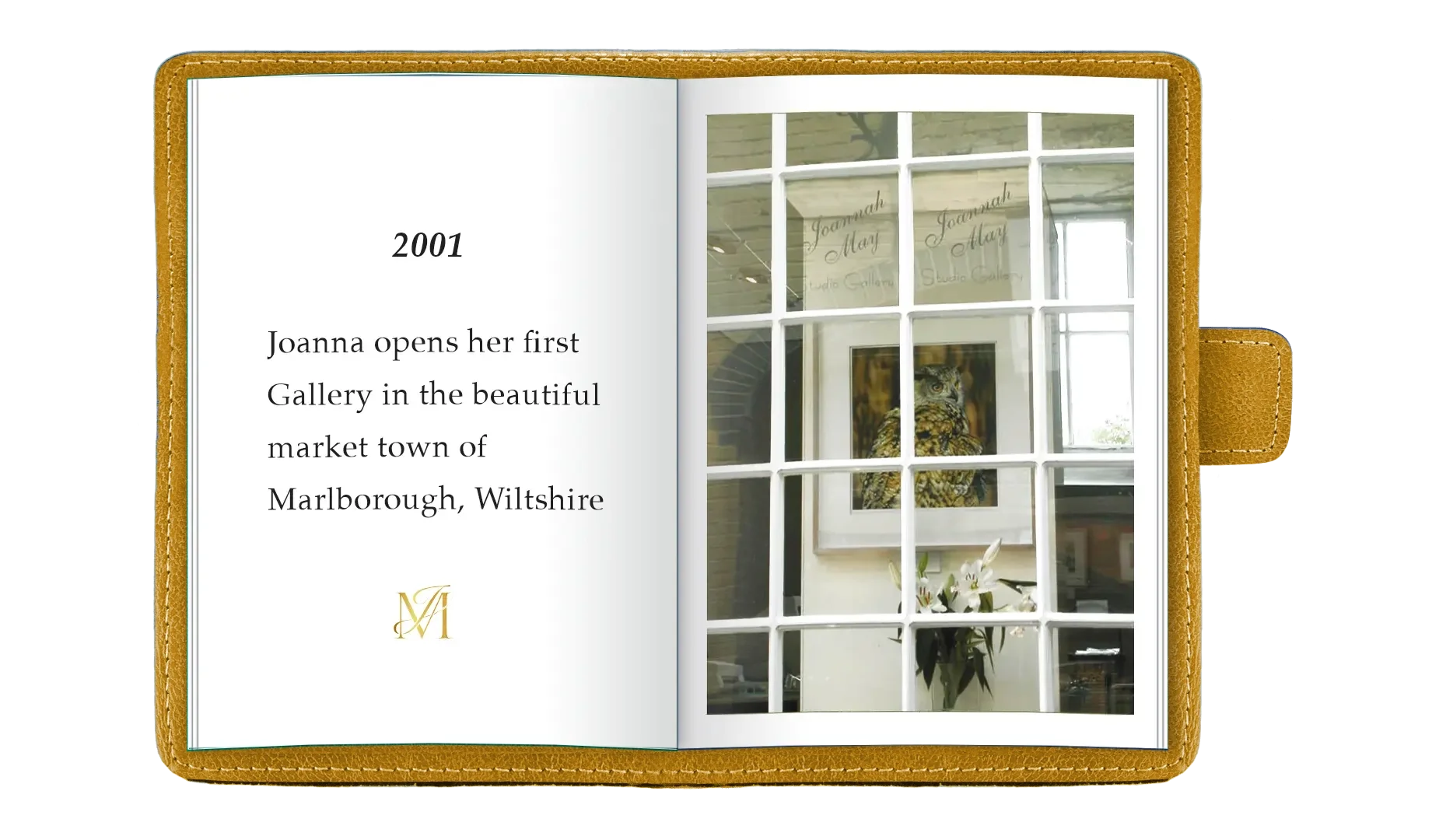 Open photo album with a page displaying the year 2001 and text about Joanna opening her first gallery in Marlborough, Wiltshire. The other page shows framed artwork of an owl through a window with multiple panes.