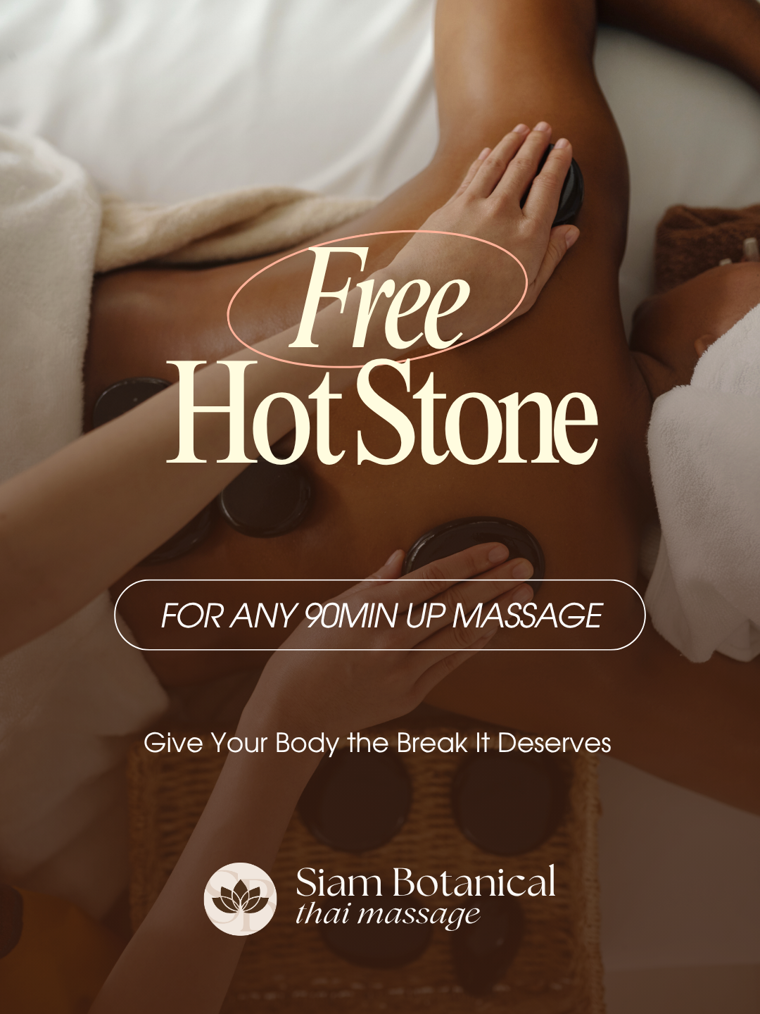 A person receiving a hot stone massage with hot stones placed on their back and a massage therapist using hands to massage.