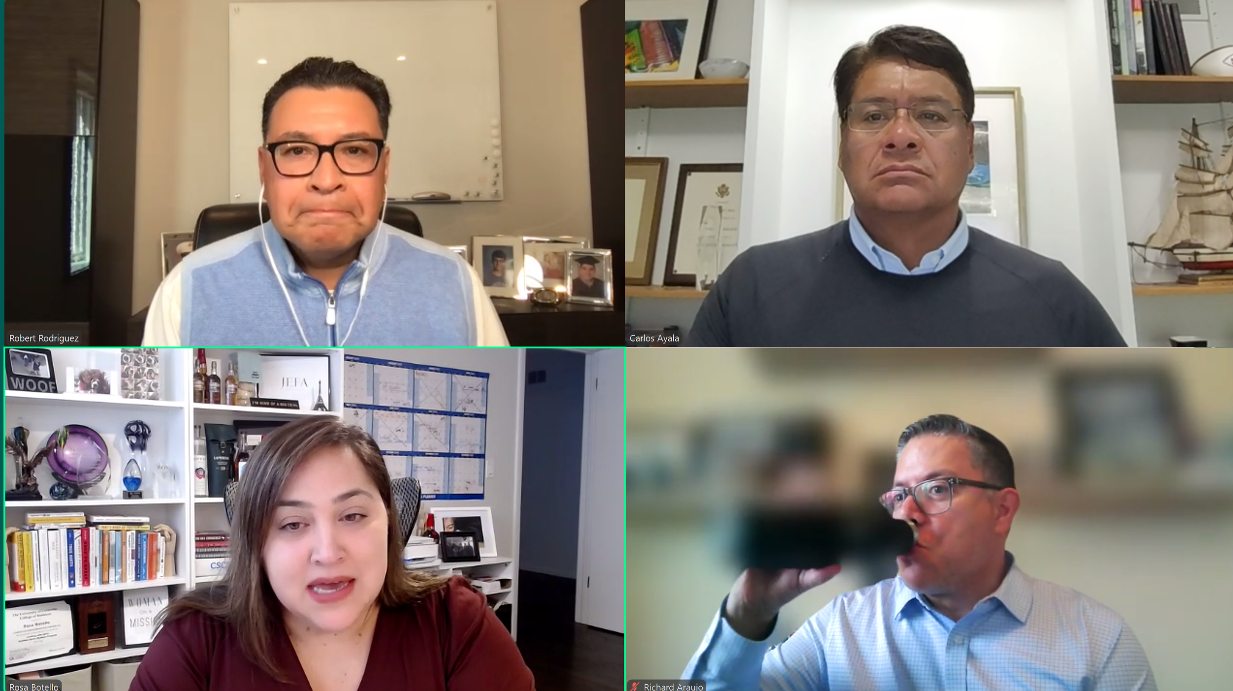 A screenshot of a video conference with six people, five men and one woman, participating remotely. They are in various home or office settings with bookshelves, framed pictures, and shelves with decorative items visible in the background.