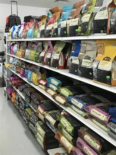 Store shelves stocked with various bags of pet food in different colors and brands.