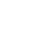 A bathtub with steam rising, a towel hanging on the side, and bubbles in the water