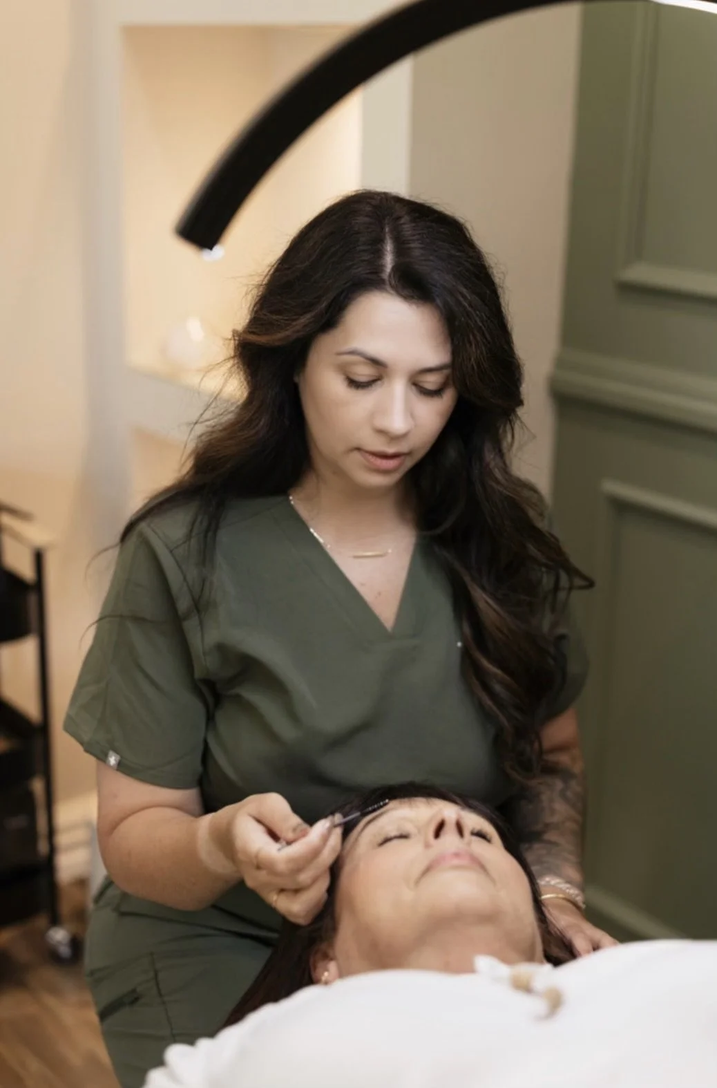 Skin specialist undertaking brow treatment in Grace & Glow studio