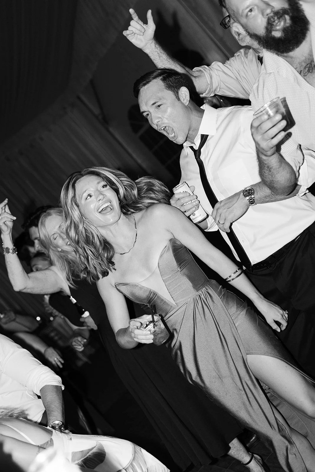 Wedding guests laughing and dancing on reception dance floor, candid Tennessee wedding photography