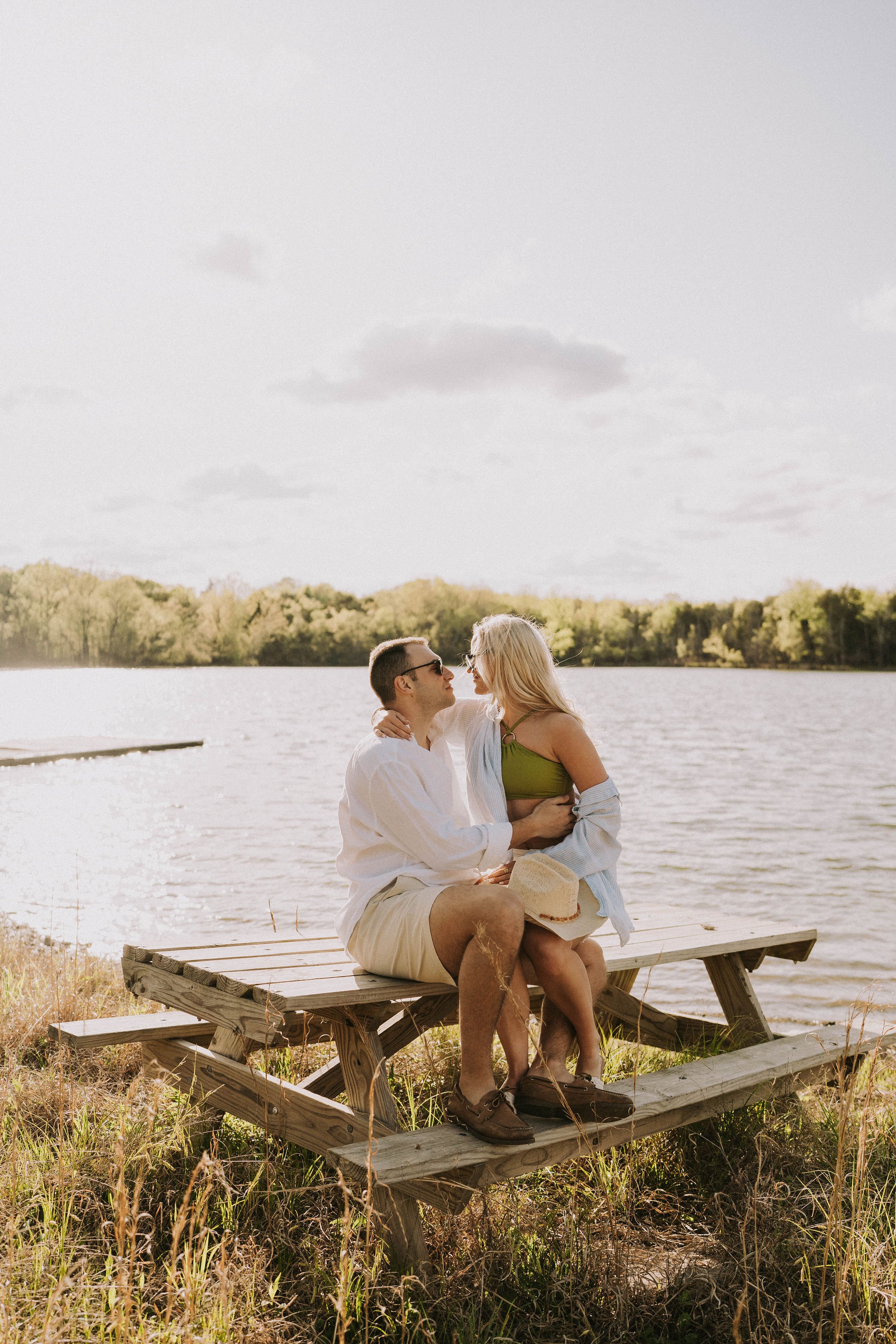 lakeside engagement session West Tennessee — couple in green and white linen.