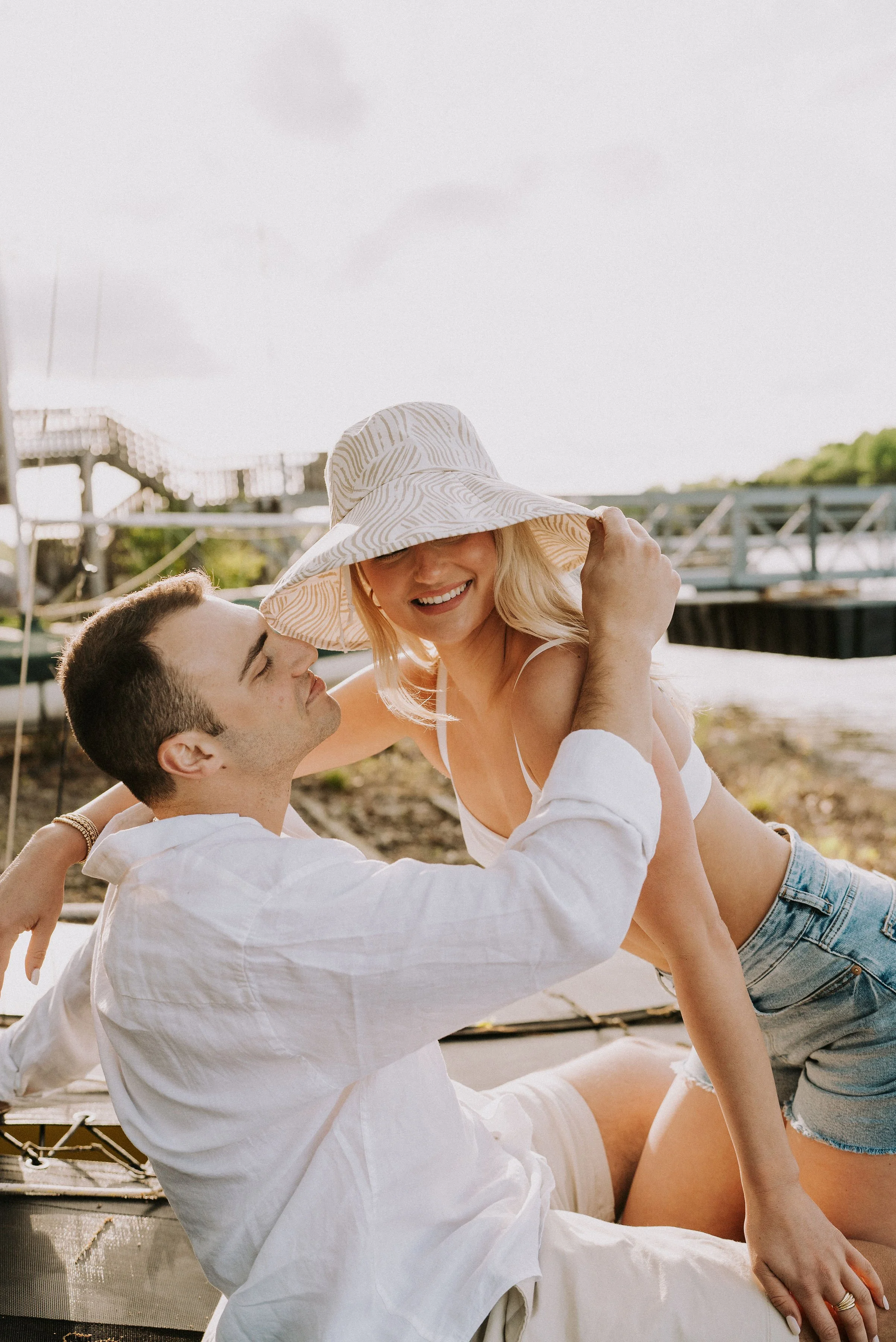 sailboat engagement session — neutral outfits with patterned hat detail, West Tennessee photographer