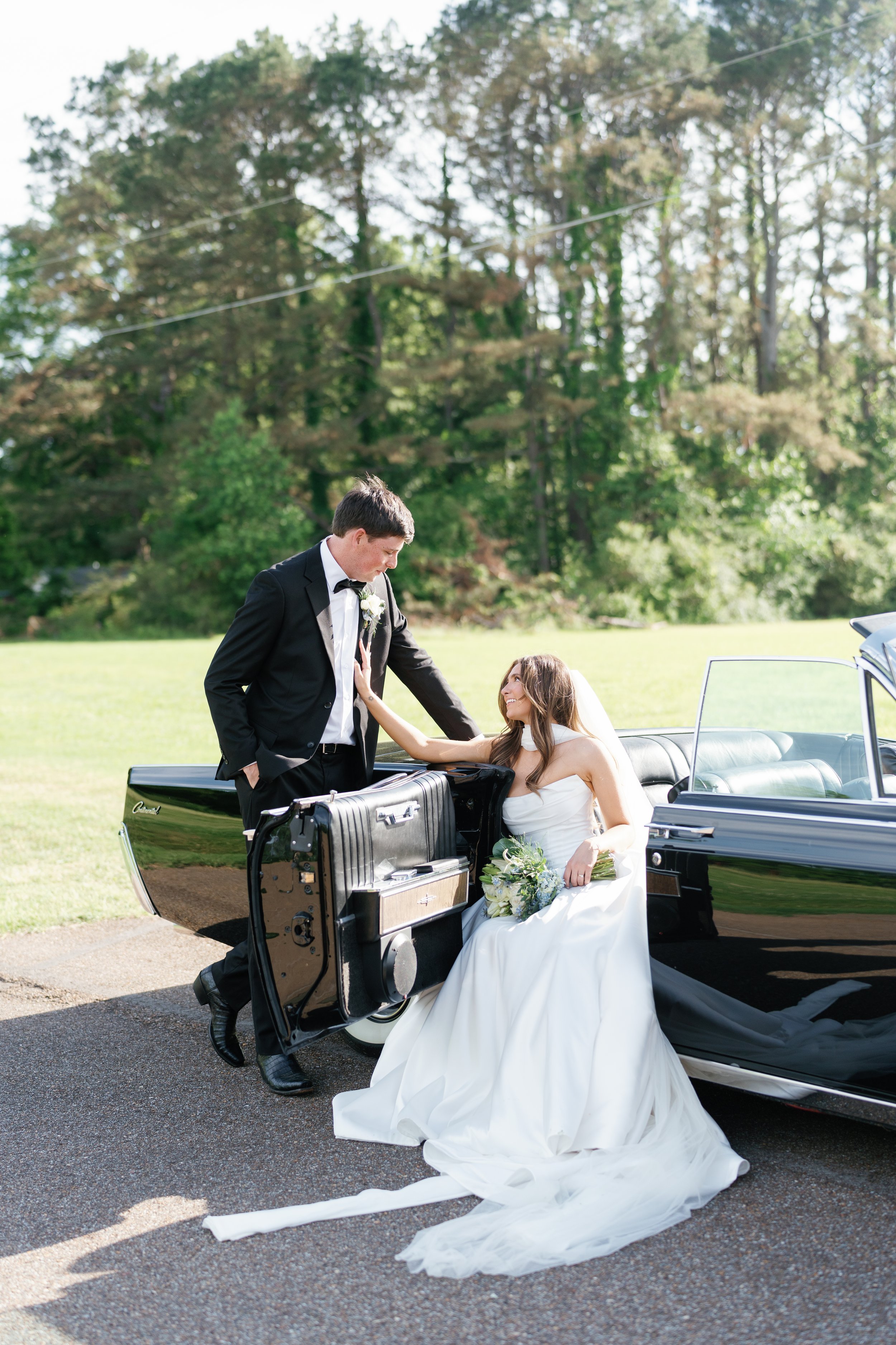 Bride and groom posing with vintage car at outdoor wedding venue, Tennessee wedding photographer