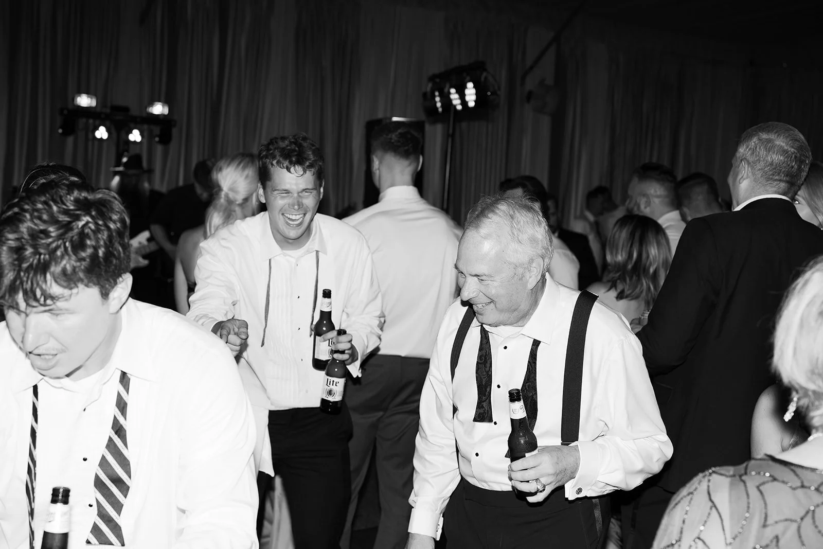 Candid guests laughing and dancing at wedding reception, Tennessee wedding photographer