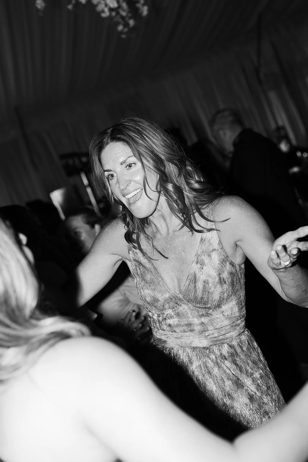 Wedding guest laughing and dancing at reception, candid flash photography, Tennessee wedding