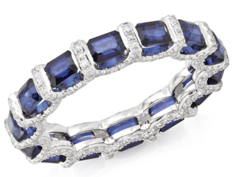 Diamond and sapphire eternity ring with blue sapphires and small diamonds set in white gold or platinum.