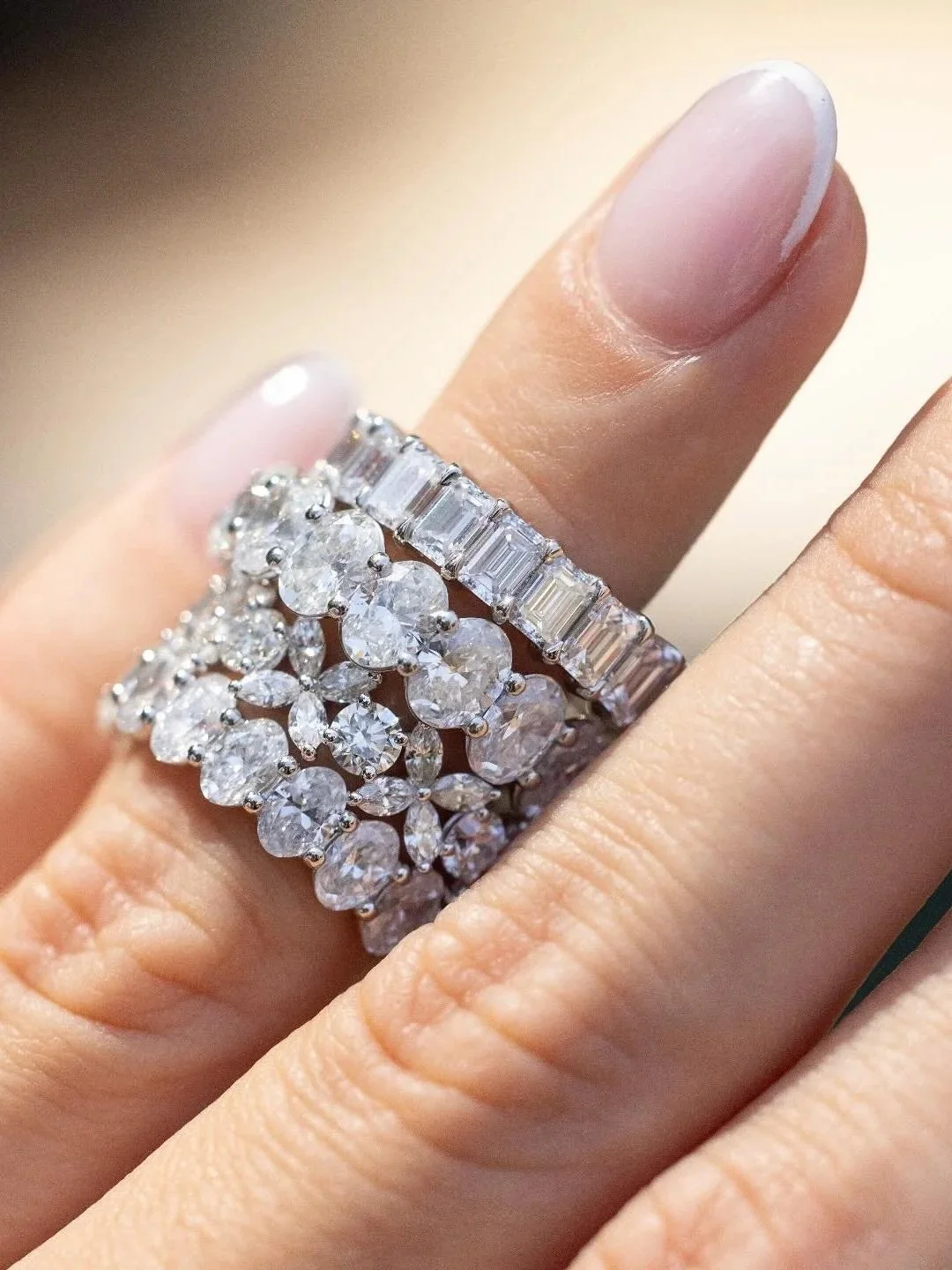 Close-up of multiple diamond eternity bands; pear, emerald and oval shape