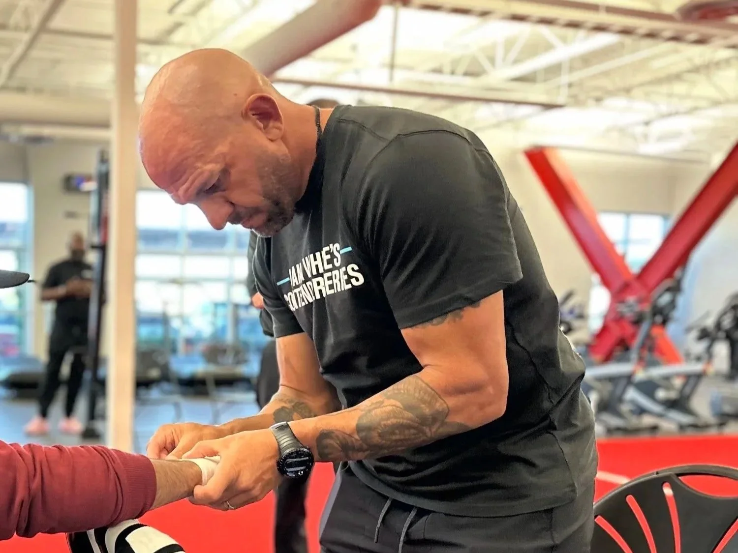 Coach Marc Montoya taping up his fighter’s hands prior to competing on Dana White’s UFC Tuesday Night Contender Series.