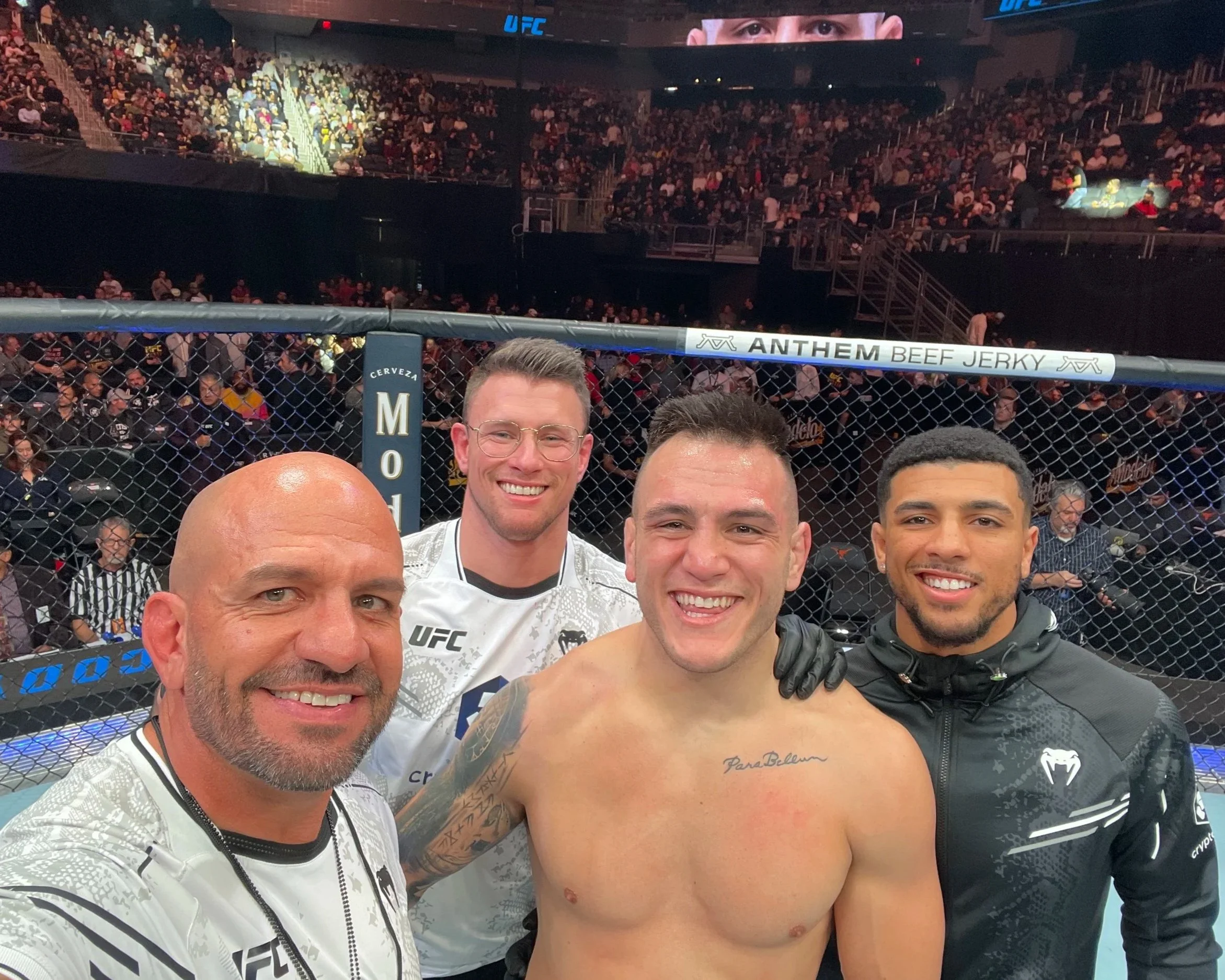 Coach Marc Montoya, former UFC fighter Collin Anglin and UFC fighter Marquel Mederos taking a selfie with UFC fighter Cody Brundage following a UFC win inside the UFC octagon.