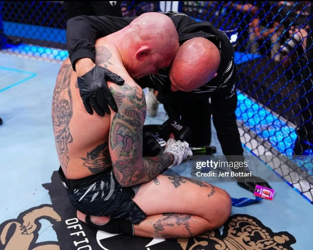 Coach Marc Montoya consoling his UFC fighter Anthony “Lionheart” Smith after a loss inside the UFC octagon. 