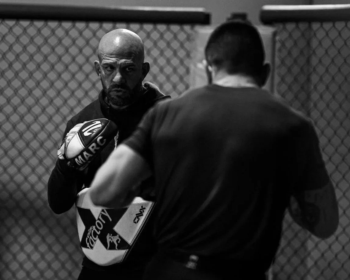 UFC fighter Cody Brundage and Coach Marc Montoya training in the cage at Factory X in Englewood, Colorado.