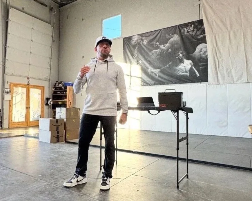 Coach Marc Montoya addressing the crowd at Factory X in Englewood, Colorado. 
