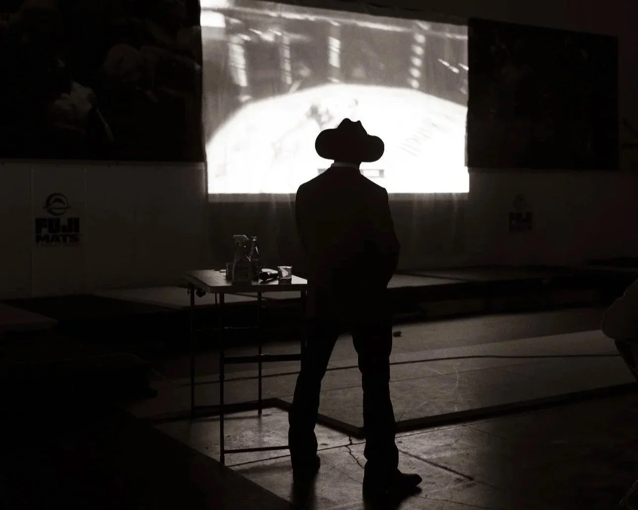 Coach Marc Montoya watching a slideshow during a speaking engagement. 