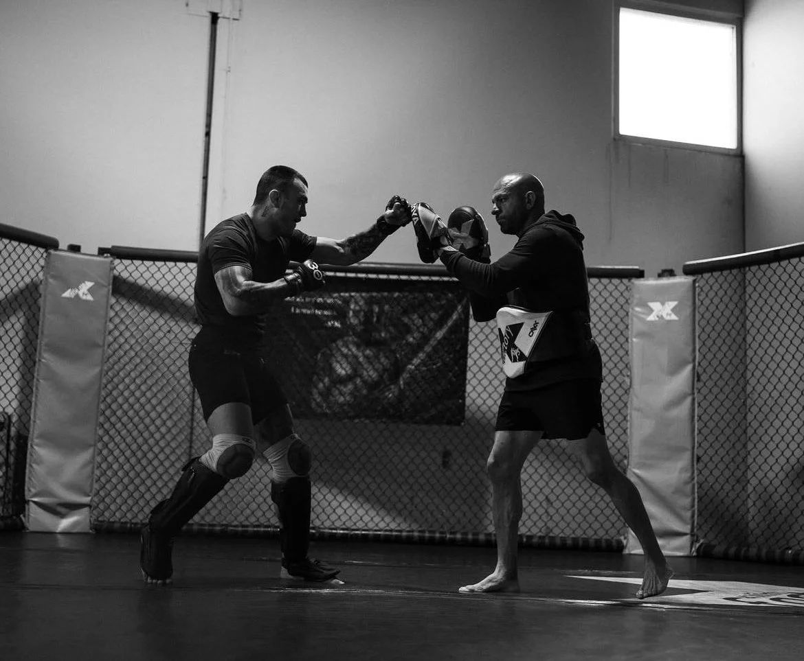 UFC fighter Cody Brundage and Coach Marc Montoya training in the cage at Factory X in Englewood, Colorado. 