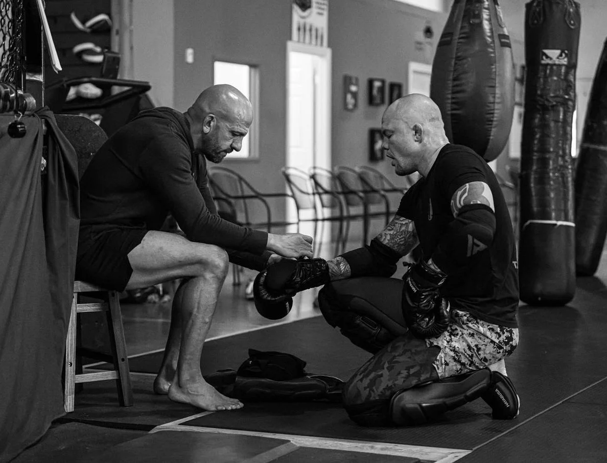 Marc Montoya lacing up the gloves of UFC fighter Anthony “Lionheart” Smith at Factory X in Englewood, Colorado. 