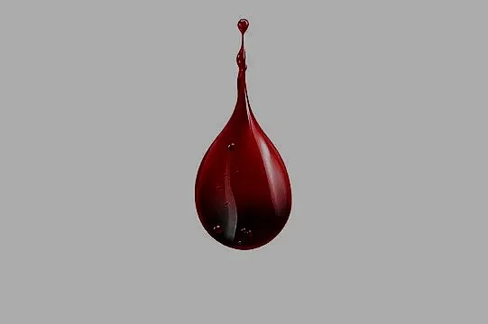 A drop of dark red liquid, likely blood or wine, falling or splashing against a gray background.