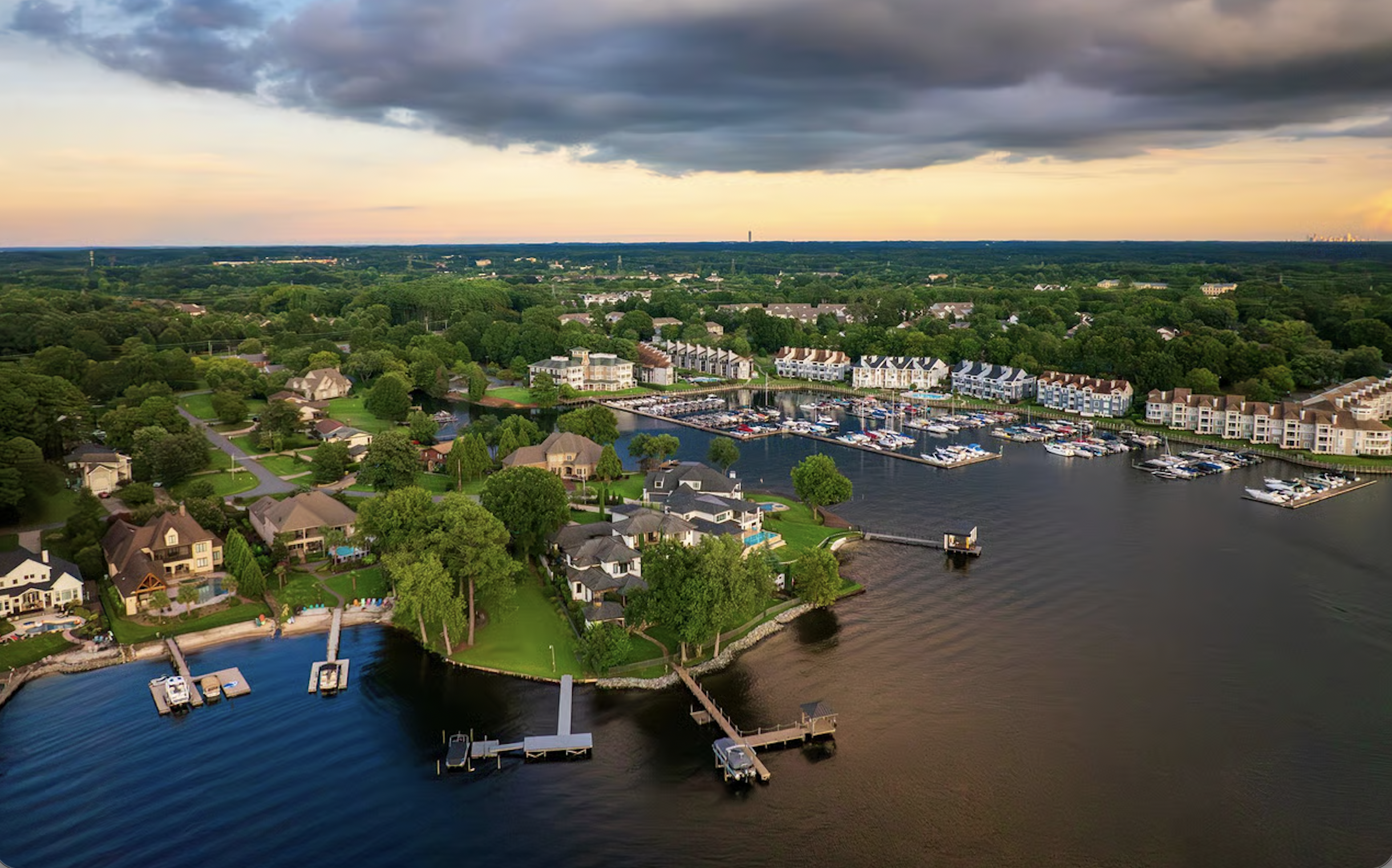 Aerial view of waterfront homes with backyard pools in Virginia Beach, Fat Cat pool cleaning service area