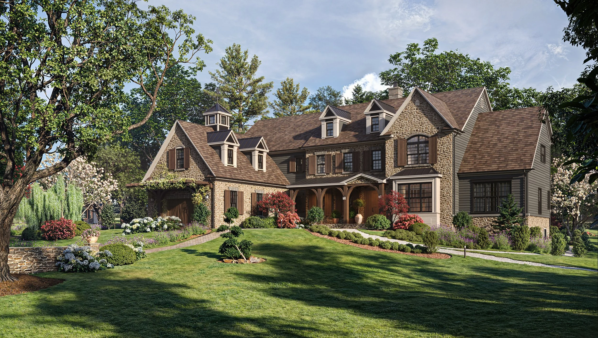 A large, elegant house with stone and siding exterior, surrounded by a lush, manicured lawn and colorful landscaping with trees, shrubs, and flowers.