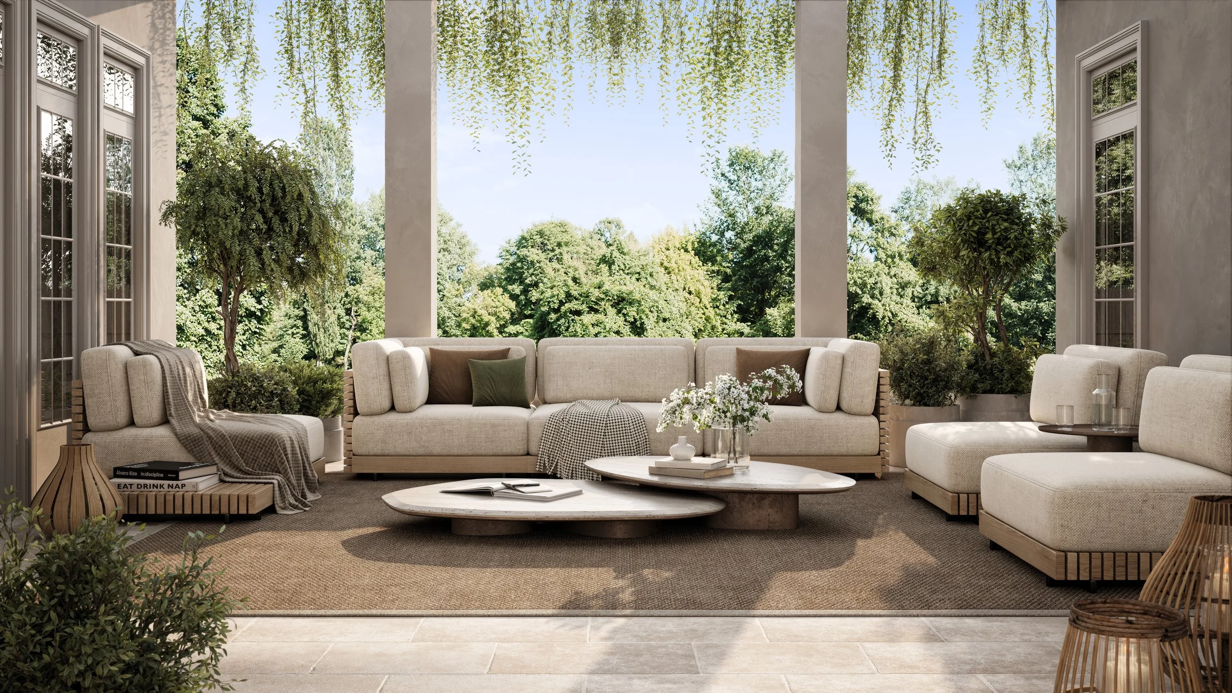 Bright, covered outdoor patio with beige sectional sofa, potted plants, and view of lush green trees.