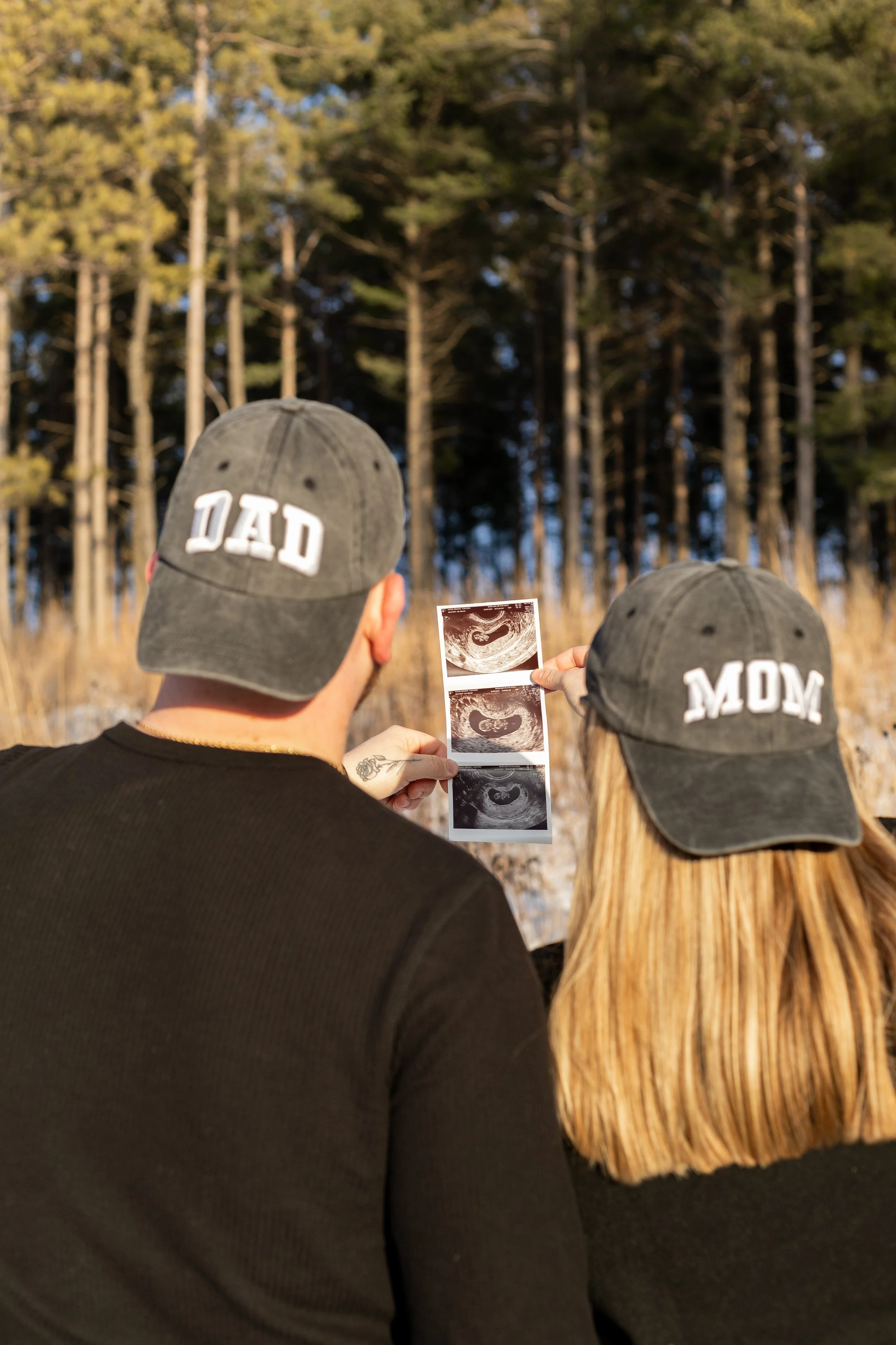 Pregnancy announcement in winter at Lapham Peak in Wisconsin
