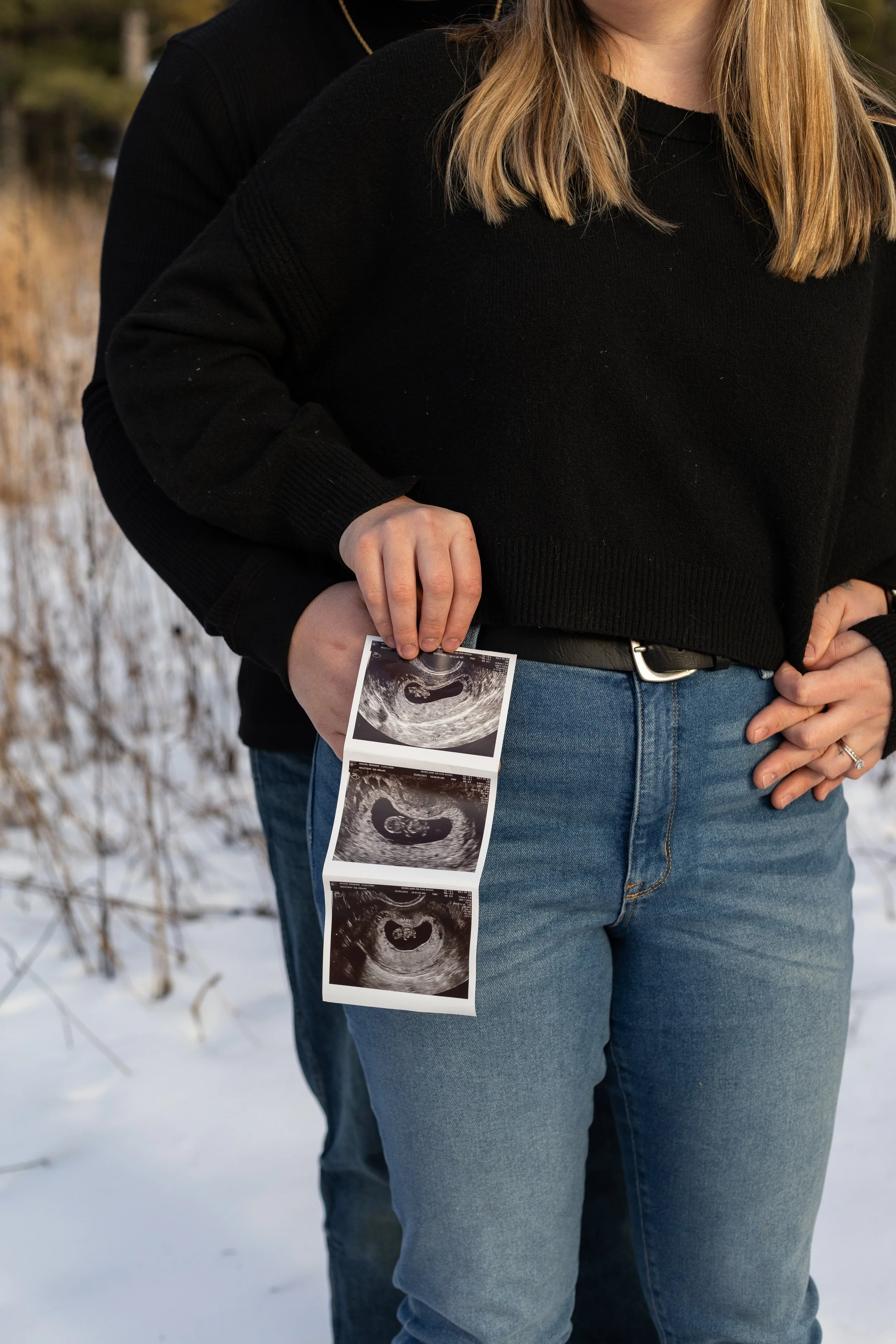Pregnancy announcement in winter at Lapham Peak in Wisconsin