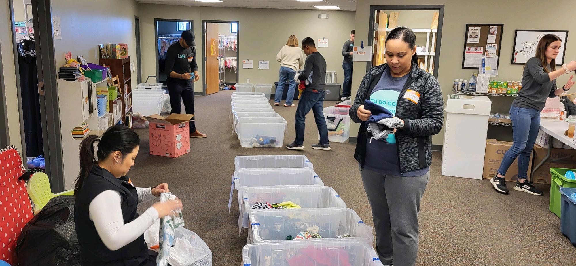 Asendo Team providing diapers, wipes, baby clothes at the Bloom Free Store.