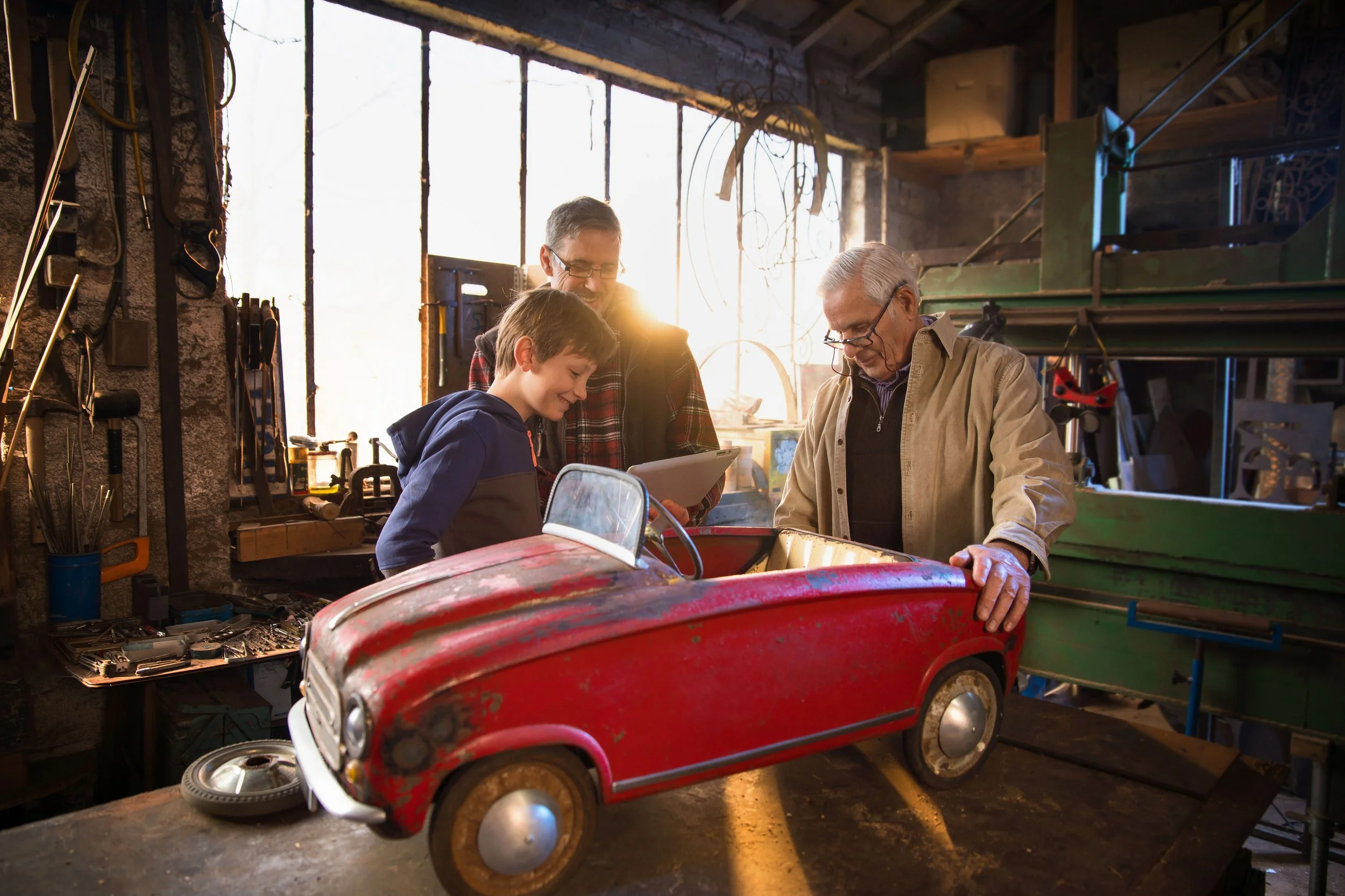 Grandson Fixing Toy Car With Dad & Grandpa