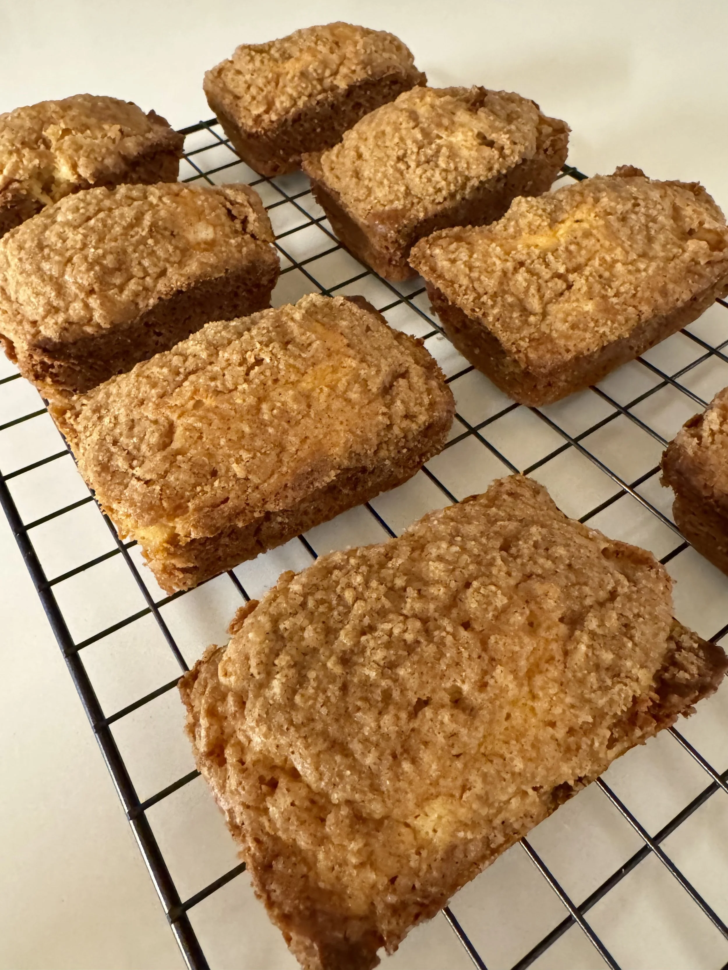 Homemade banana crumb muffins cooling on a wire rack.