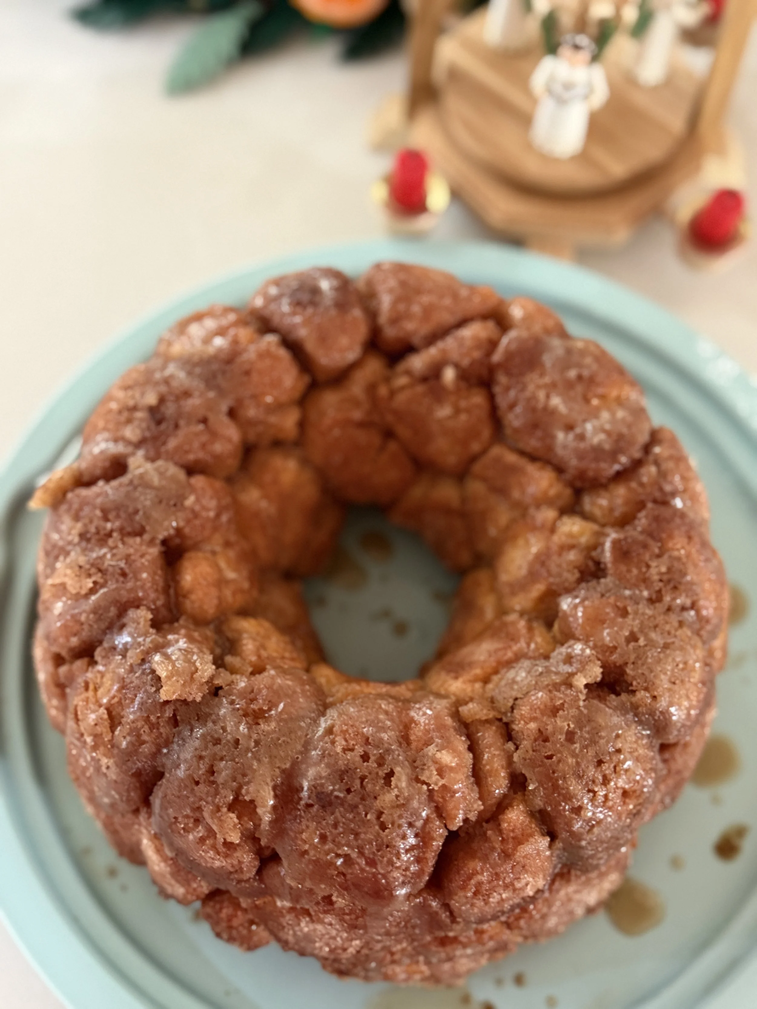 A close-up of a caramel apple cake with a crumble topping on a light blue plate.