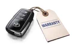 Car key with Toyota logo and a warranty tag.