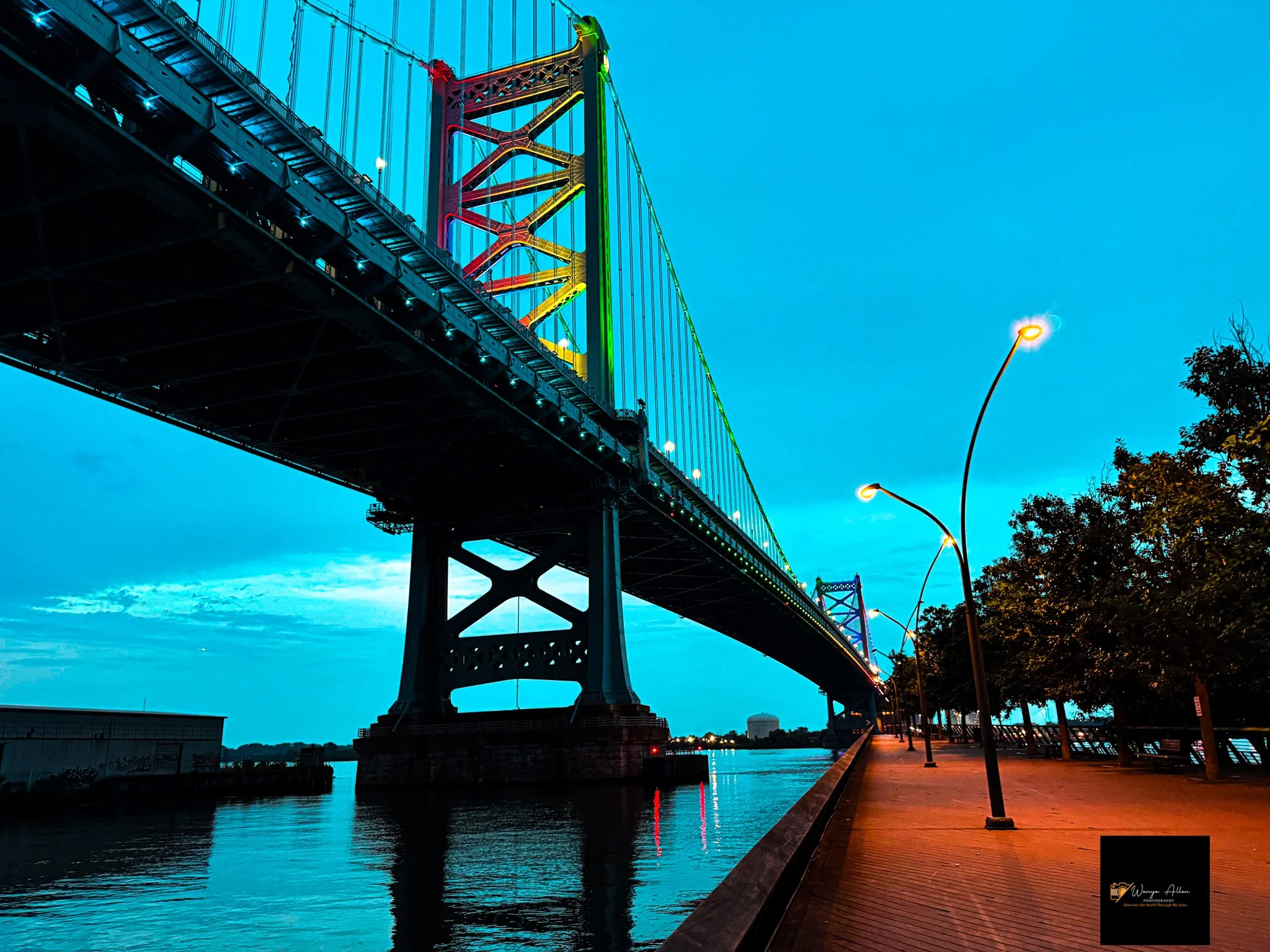 A Beacon of Pride: The Benjamin Franklin Bridge Illuminated in Rainbow Glory