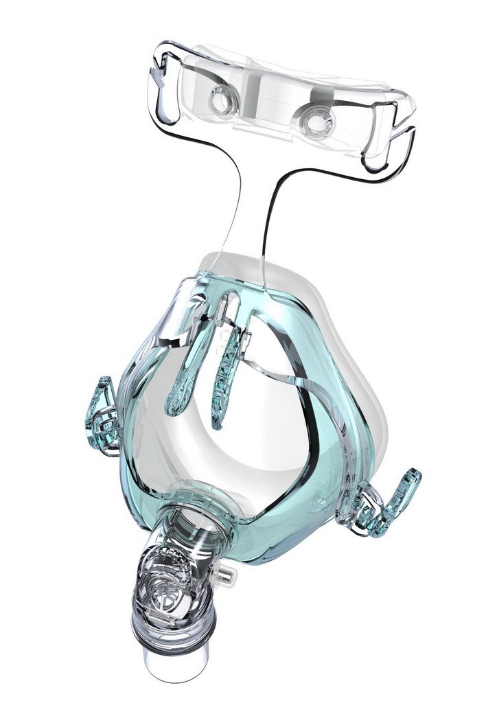 A transparent mechanical ventilator mask with adjustable straps and a greenish-blue plastic frame, designed to cover the nose and mouth for medical respiratory support.
