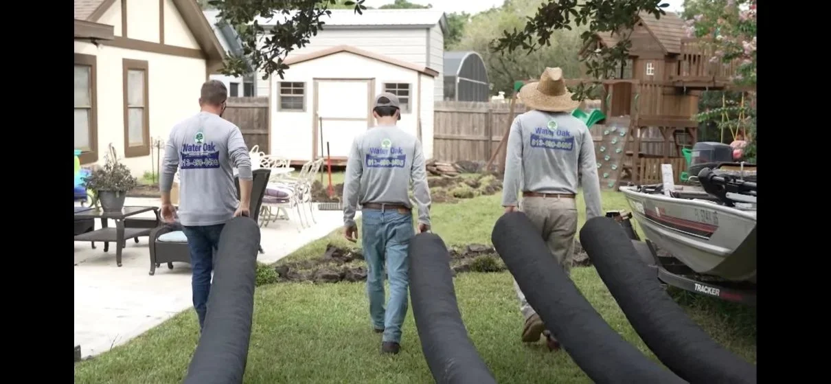 Installing a French drain in Florida. Men walk with NDS drainage products ready for French drain installation.