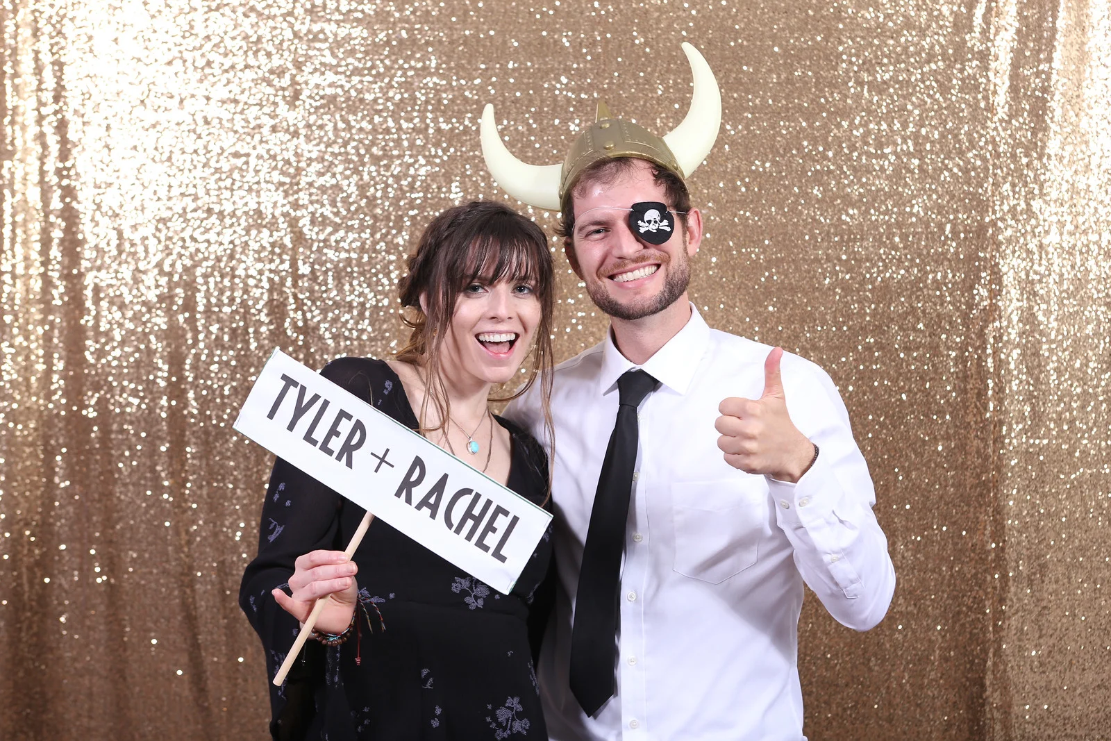 Couple in front of gold backdrop