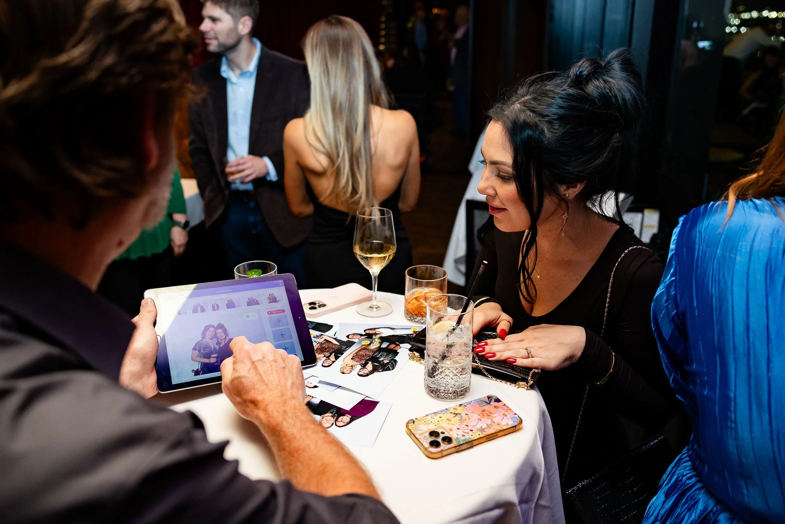 Side-A Portrait Booth: Woman works with booth attendant to review portrait options