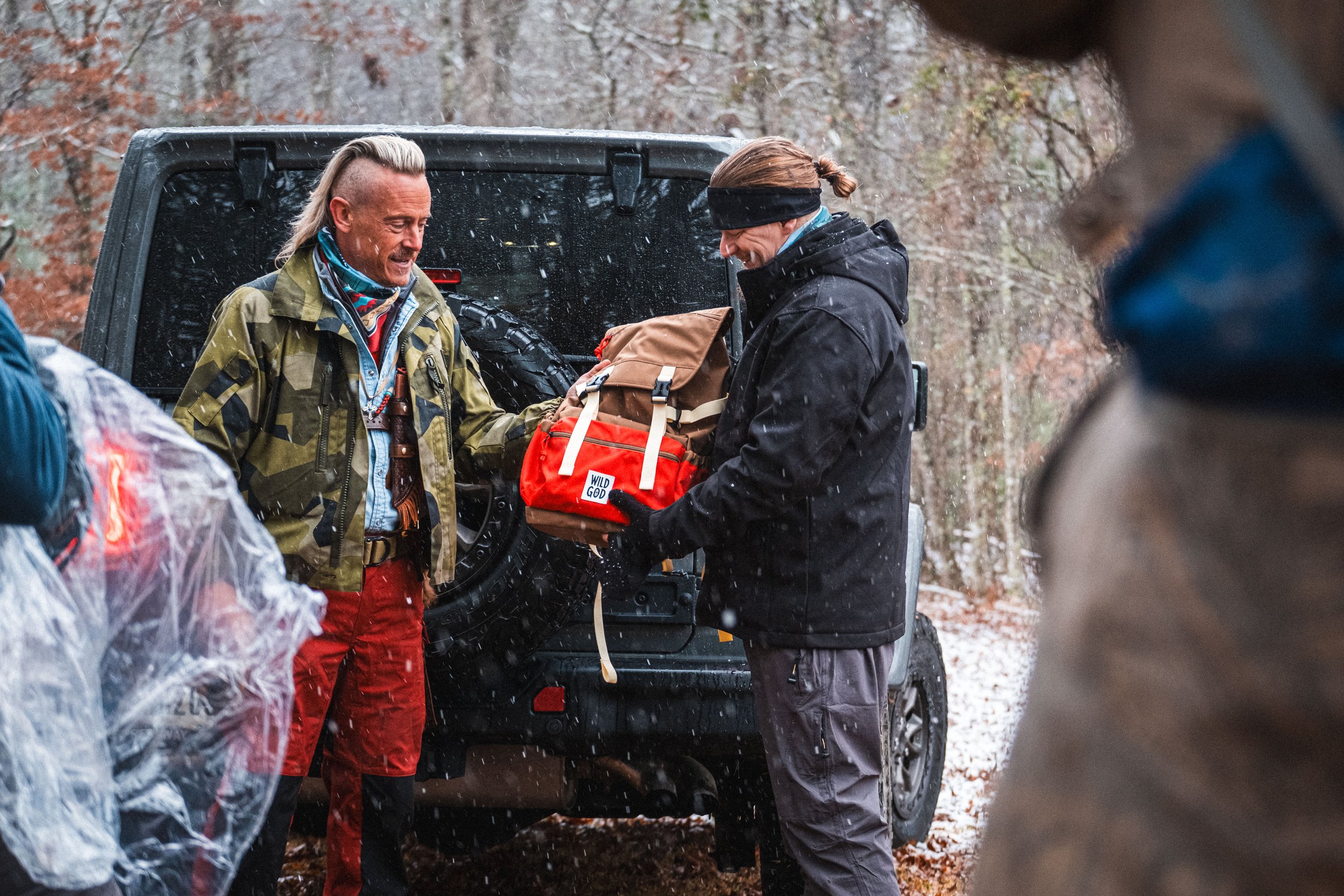 Creek handing Mark his pack for the week, which only included 5 items!