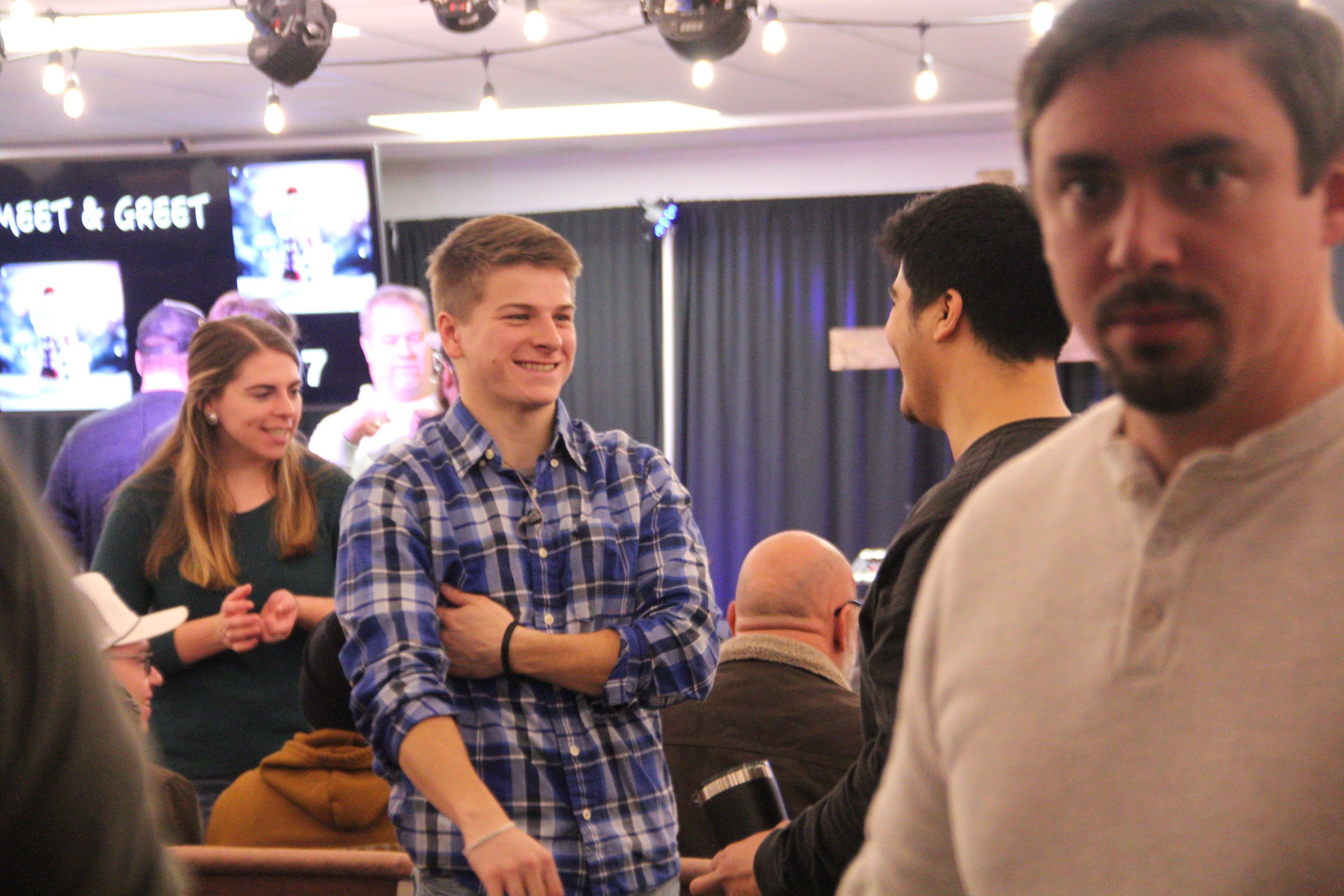 Men share conversation and friendship at a Redeemer City Church gathering