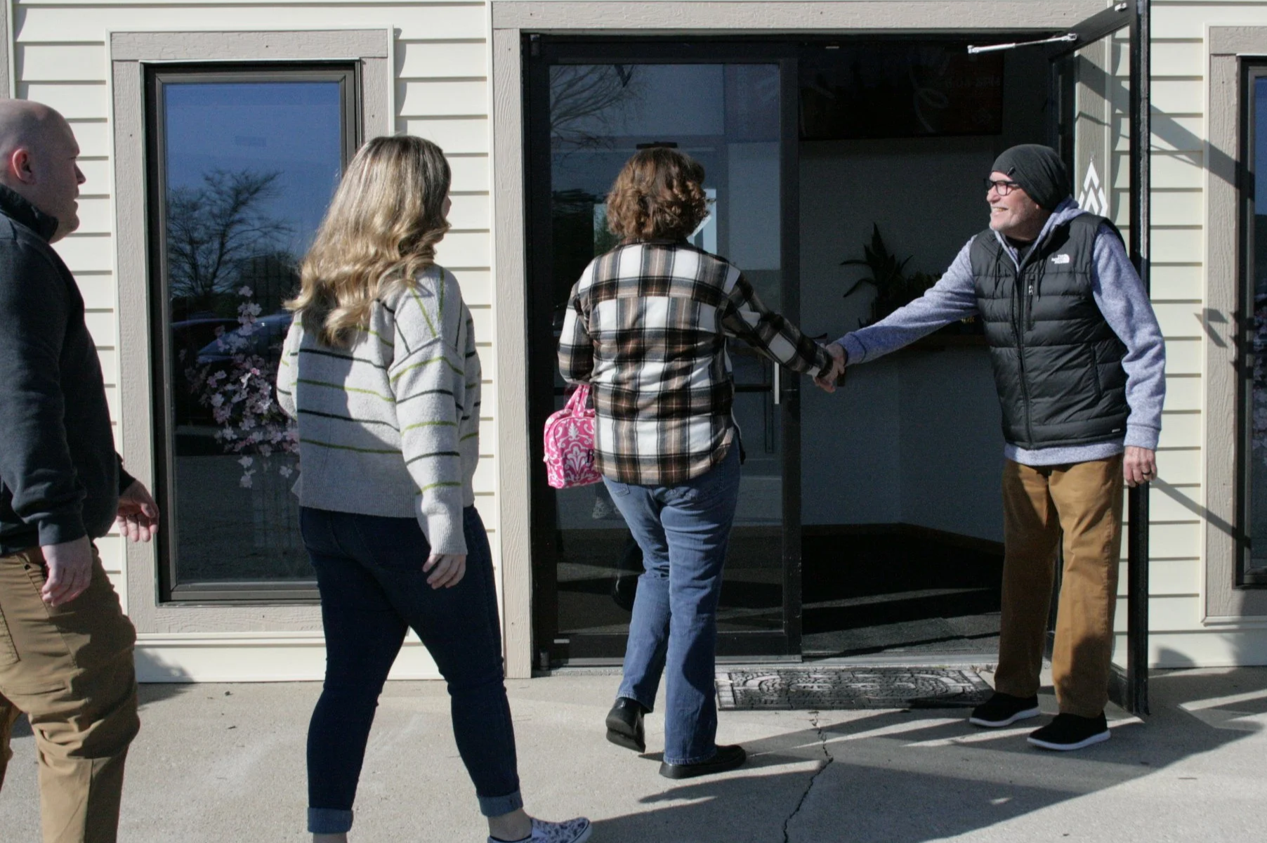 A greeter welcomes people at the entrance to Redeemer City Church