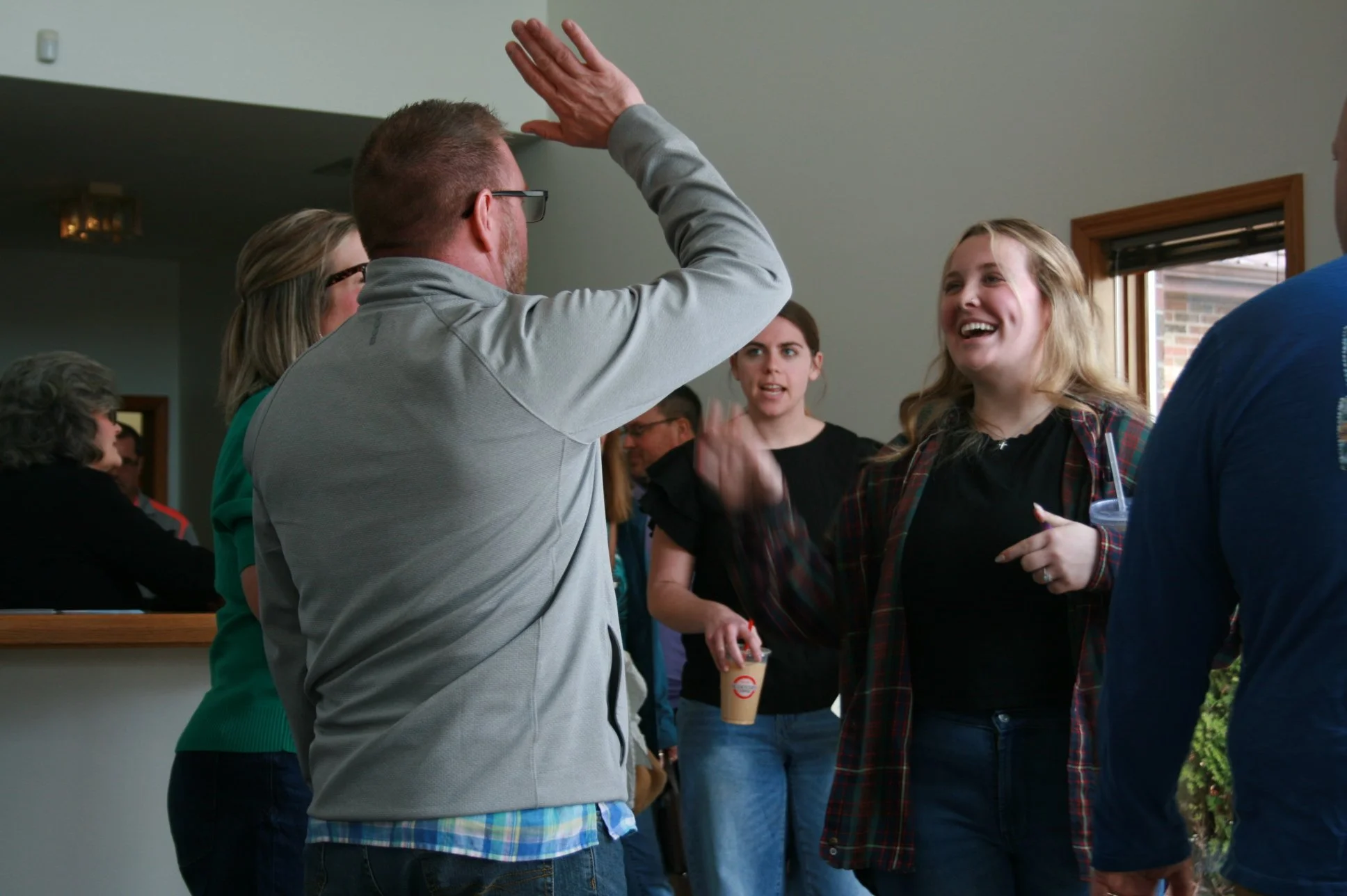 People share a high five and smiles at Redeemer City Church