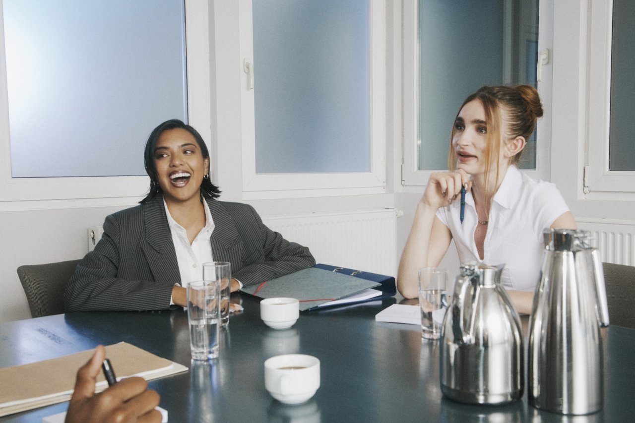 A Winnipeg professional woman sitting at a conference table with her executive assistant in Winnipeg