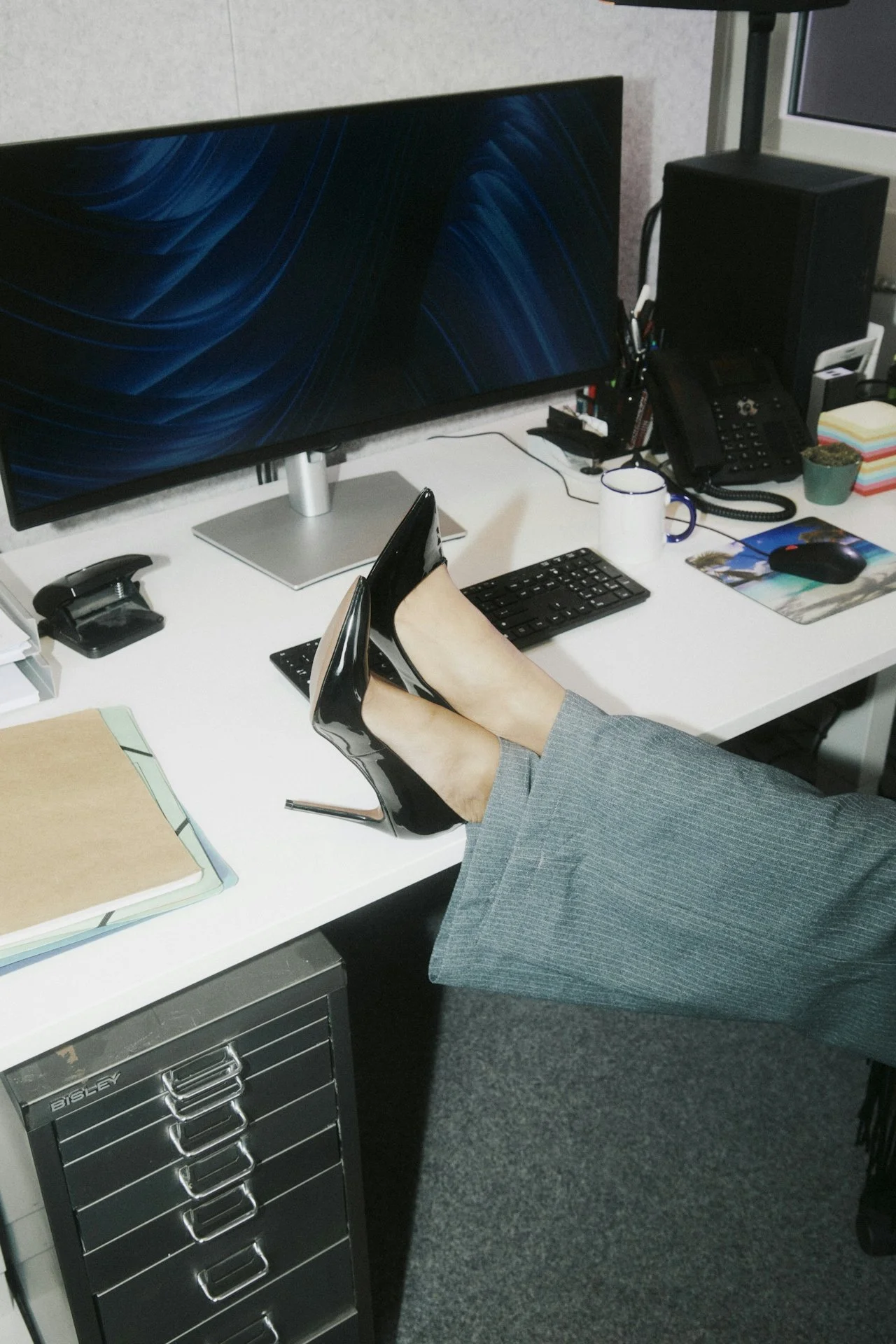 Winnipeg admin assistant sitting with her feet up on desk