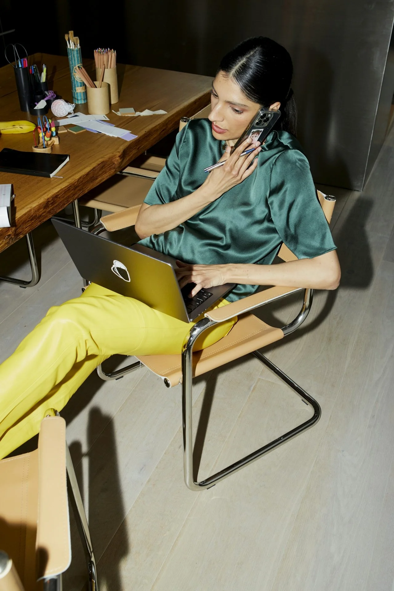 A personal assistant hired for a Winnipeg small business works on invoices or her laptop while taking a client call
