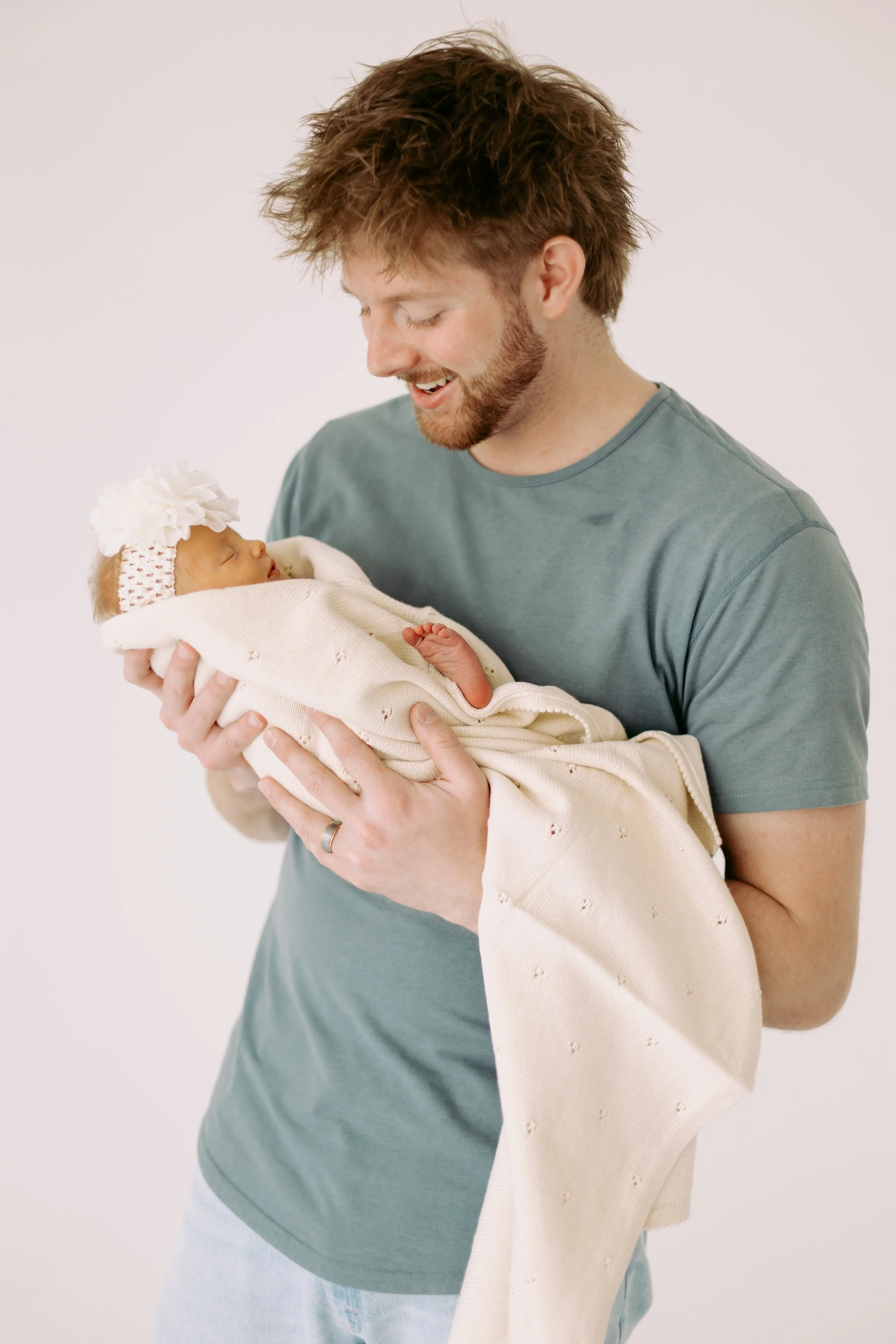 dad holding baby newborn photos