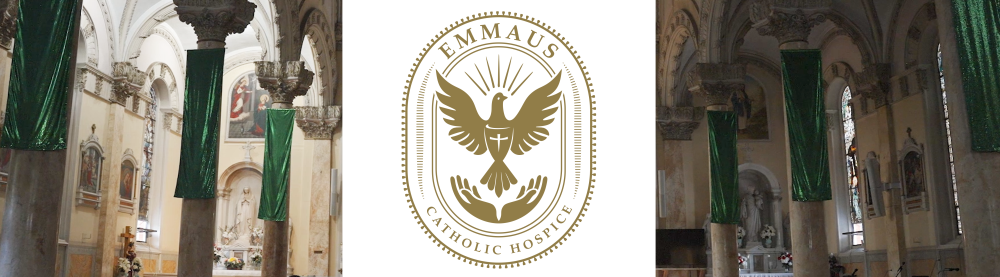 Interior of a church with tall columns wrapped in green fabric, artwork, and stained glass windows; central logo for Emmaus Catholic Hospice featuring a stylized dove with a cross and the name encircled by a dotted line.