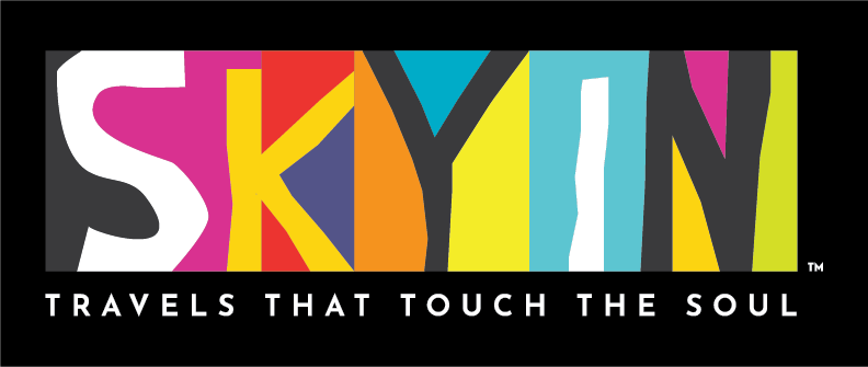Colorful logo with the word "SKYIN" and the tagline "Travels That Touch the Soul" in white letters on black background.