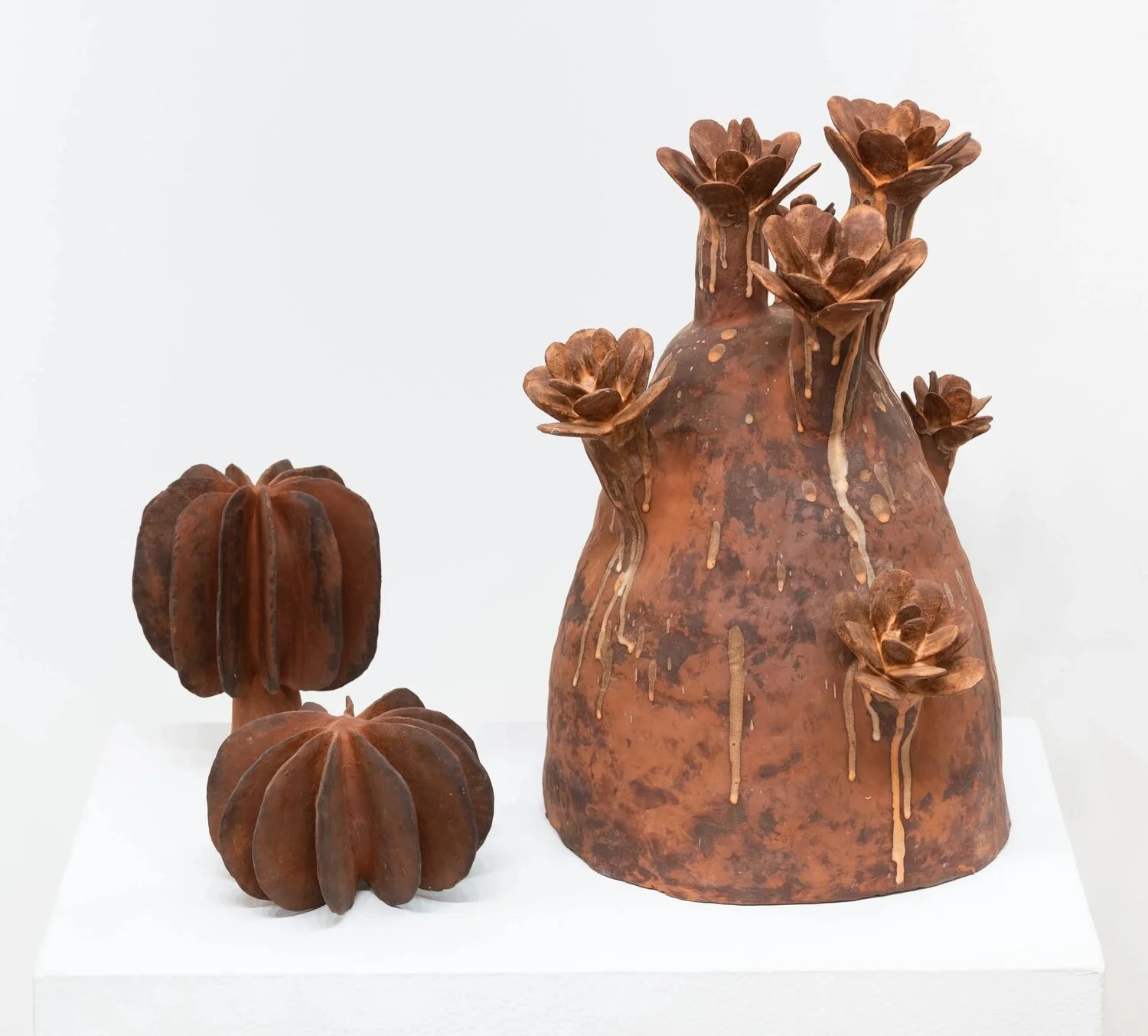  #4, 2019 (left)  Ceramic  5 × 7 × 7 inches    Flora #38, 2023 (right)  Glazed ceramic  17.7 x  17 × 13.4 inches 