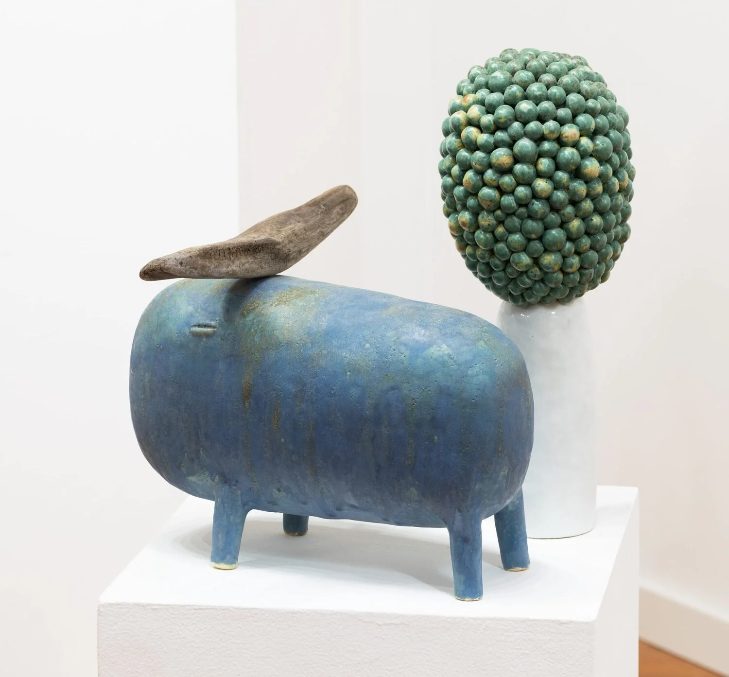  #62, 2023 (left)  Glazed ceramic and wood  11 × 13.5 × 12 inches    #22, 2023 (right)  Glazed ceramic  16.5 × 6.3 × 6.3 inches 